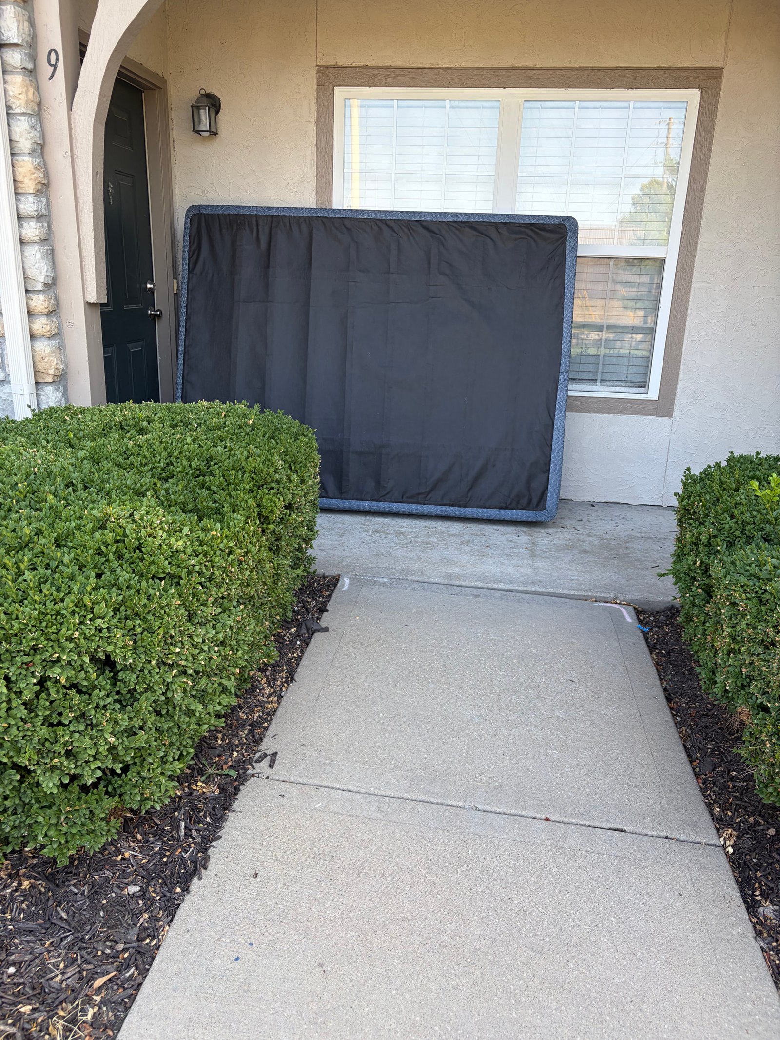 Box spring staged outside a home